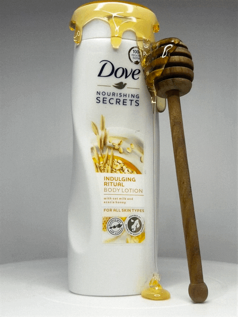 dove honey and oat milk body lotion with honey dripping down the product and a honey stick GIF
